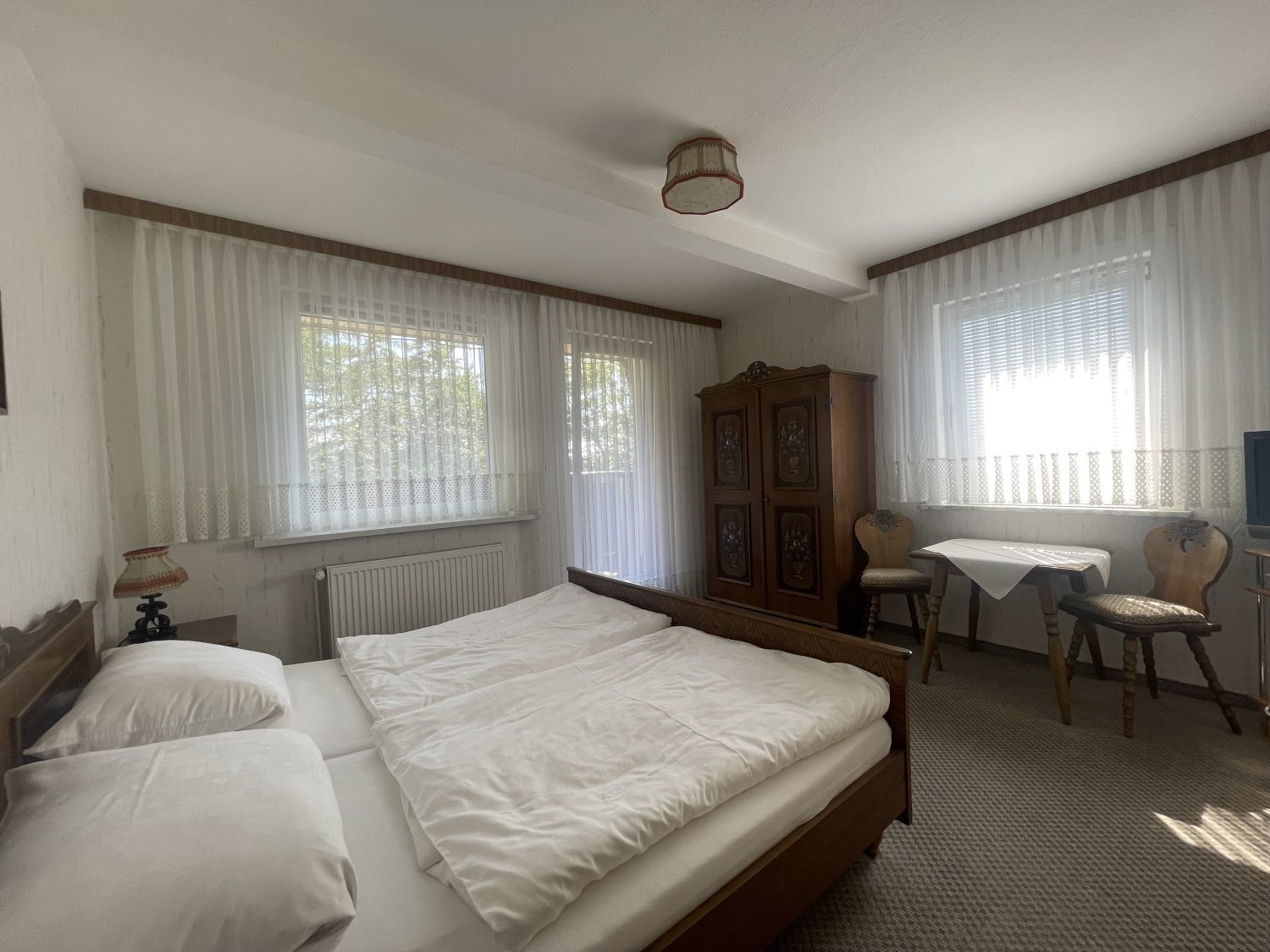 Schlafzimmer mit Doppelbett, Schrank und Sitzecke